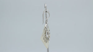 Sterling silver tribal earrings with Mother Of Pearl diamond panels and silver sunburst accents.