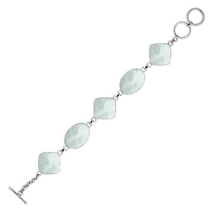 Sterling silver bracelet with alternating oval and cushion mother of pearl links, polished finish