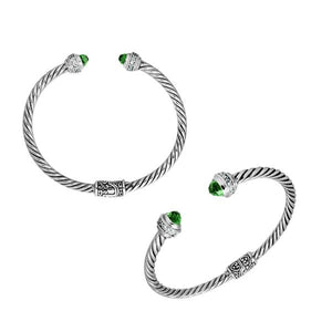Sterling silver wholesale bangle with twisted rope design, featuring Green Quartz and Cubic Zirconia end caps with Balinese motifs.