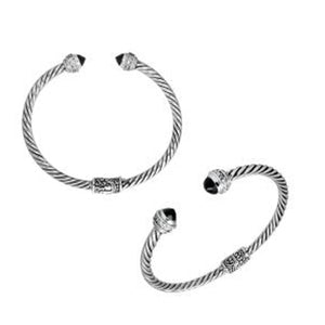 Sterling silver wholesale bangle with twisted rope design, Black Onyx and Cubic Zirconia accents, handcrafted Balinese motifs.