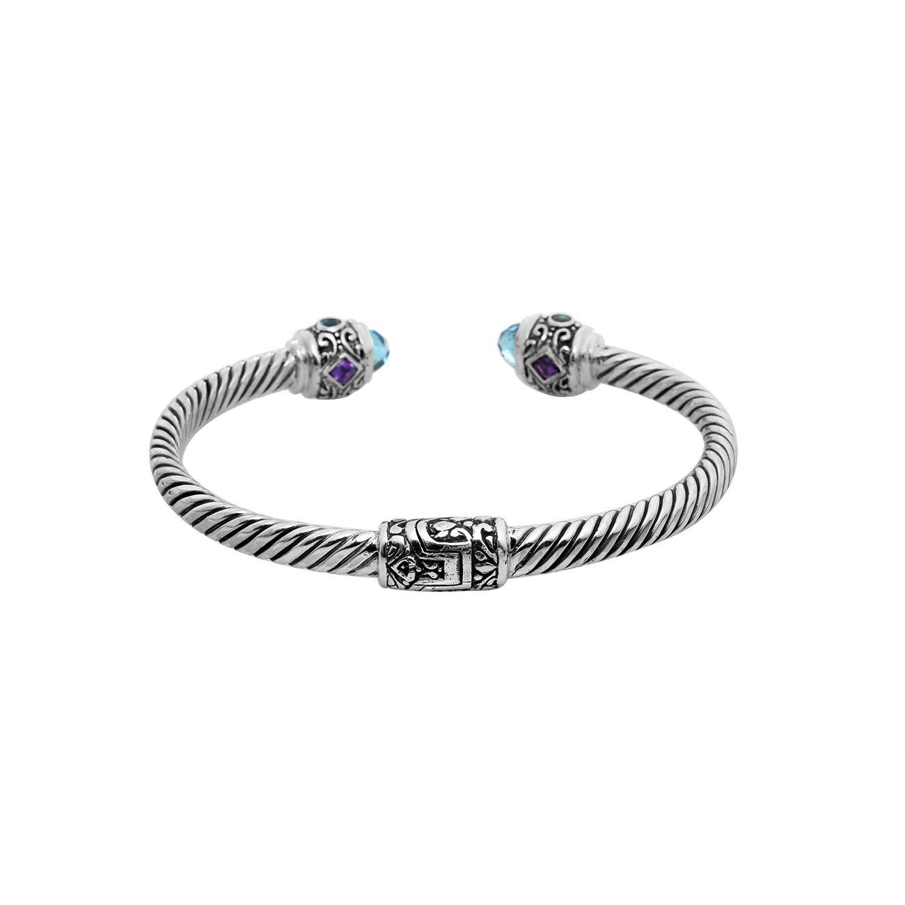 Sterling silver twisted bangle with Amethyst Quartz and Blue Topaz Quartz handcrafted in Bali.