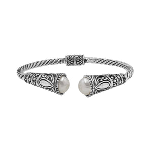 Sterling silver twisted bangle with pearl ends and oxidized Balinese design