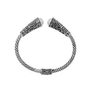 Sterling silver twisted bangle with pearl ends and oxidized Balinese design