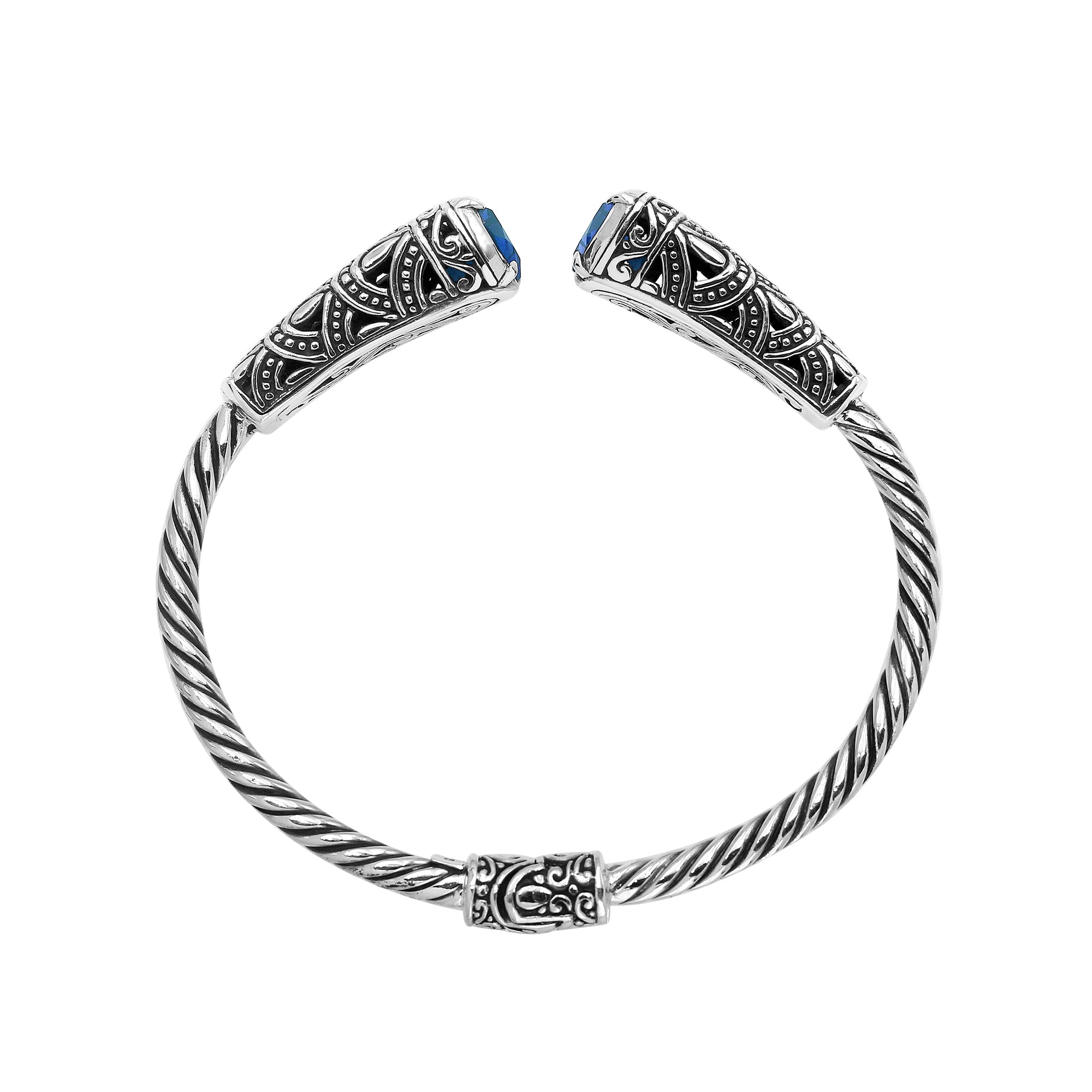 Sterling silver twisted bangle with blue topaz quartz ends and oxidized Balinese design
