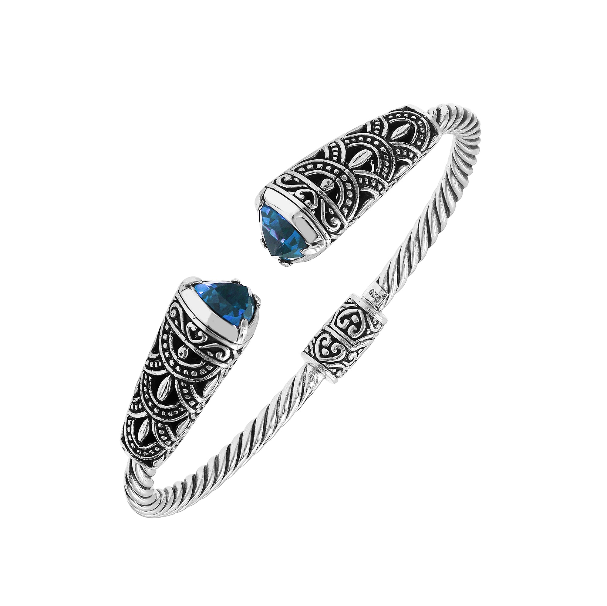 Sterling silver twisted bangle with blue topaz quartz ends and oxidized Balinese design