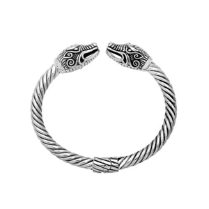 Sterling silver twisted bangle with dragon face design and oxidized Balinese pattern