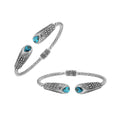 Sterling silver twisted bangle with blue topaz quartz ends and Balinese oxidized dot pattern