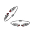 Sterling silver twisted bangle with garnet quartz ends and Balinese oxidized dot pattern