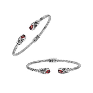 Silver twisted cable bangle in 925 sterling silver with pear-shaped Garnet Quartz and Balinese scroll engraving.