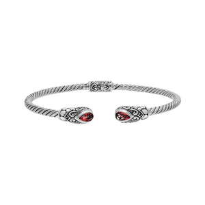Silver twisted cable bangle in 925 sterling silver with pear-shaped Garnet Quartz and Balinese scroll engraving.