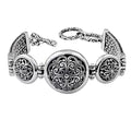 Sterling Silver round panel bracelet featuring raised scroll pattern links, sturdy construction, and a secure toggle lock suitable for dependable wholesale jewelry assortments.