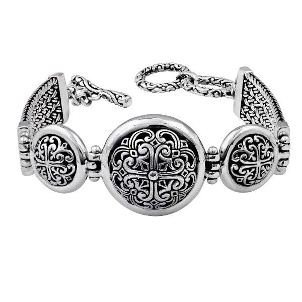 Sterling Silver round panel bracelet featuring raised scroll pattern links, sturdy construction, and a secure toggle lock suitable for dependable wholesale jewelry assortments.