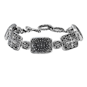 Sterling Silver bracelet featuring rectangular ornate scroll panels, polished connector links, and a secure toggle lock designed for reliable wholesale jewelry assortments.