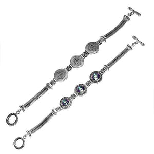 Sterling silver artisan bracelet with Mystic Quartz, circular decorative motifs, braided chain strands, and a toggle lock.