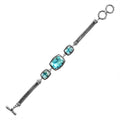 Wholesale sterling silver bracelet featuring three cushion Blue Topaz Quartz stones, ornate Balinese frames, woven chain detailing, and a secure toggle lock for catalog-ready presentation.