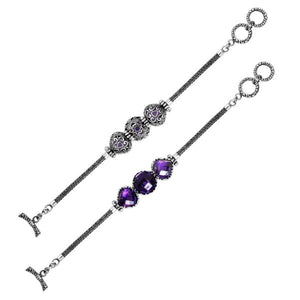 Wholesale sterling silver bracelet featuring three vibrant Amethyst Quartz stones framed in ornate Balinese settings with a woven chain and secure toggle lock for catalog-ready presentation.