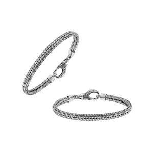 A beautifully crafted sterling silver woven bracelet with a secure lobster clasp, featuring intricate chain detailing and a mirror-polished high-gloss finish for elegant collections.