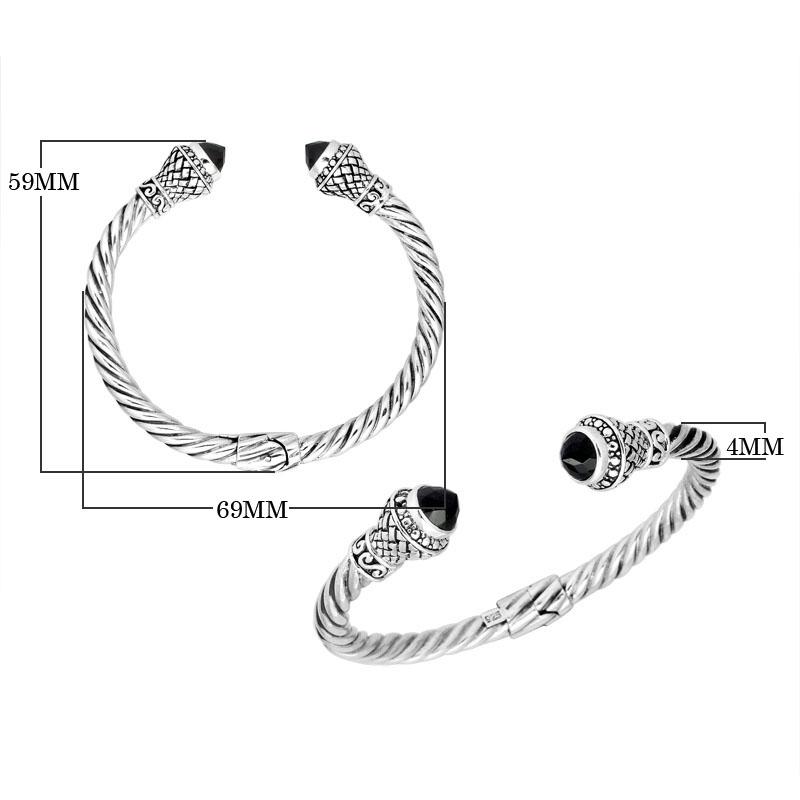 Sterling silver twisted cuff bracelet with Black Onyx caps and detailed oxidized Balinese motifs.