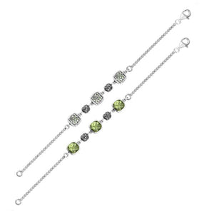 Wholesale sterling silver bracelet featuring green amethyst quartz stones, intricate Bali filigree links, and a polished–oxidized finish suitable for premium bulk jewelry collections.