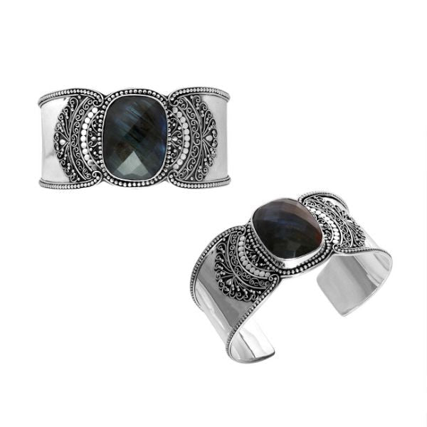 Wholesale sterling silver Bali engraved wide cuff bracelet featuring a bold labradorite centerpiece, enhanced with polished–oxidized detailing for premium bulk jewelry selection.