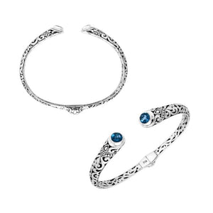 Wholesale sterling silver Bali engraved hinge cuff bracelet featuring sparkling blue topaz quartz ends and polished–oxidized detailing, crafted for premium artistic wholesale jewelry assortments and elevated inventory selections.