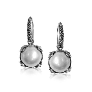 Wholesale sterling silver Mabe Pearl crown-frame earrings with polished finish and earwire lock.