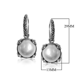 Wholesale sterling silver Mabe Pearl crown-frame earrings with polished finish and earwire lock.