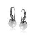 Wholesale sterling silver Shell Pearl earrings with leaf-cap design and earwire lock.