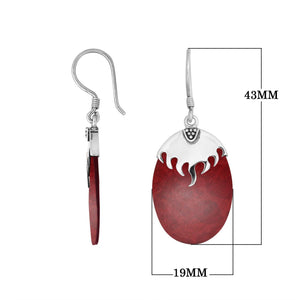 Wholesale sterling silver earrings featuring Red Coral ovals topped with a polished structured silver cap.