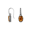 Wholesale sterling silver earrings featuring oval Citrine Quartz in scroll-accented frames.