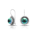 Green Mabe Pearl sterling silver artisan earrings featuring a sunburst textured frame with polished earwire hooks, designed as handcrafted statement dangle jewelry.