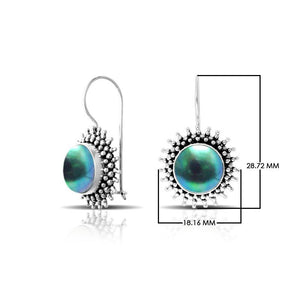 Green Mabe Pearl sterling silver artisan earrings featuring a sunburst textured frame with polished earwire hooks, designed as handcrafted statement dangle jewelry.