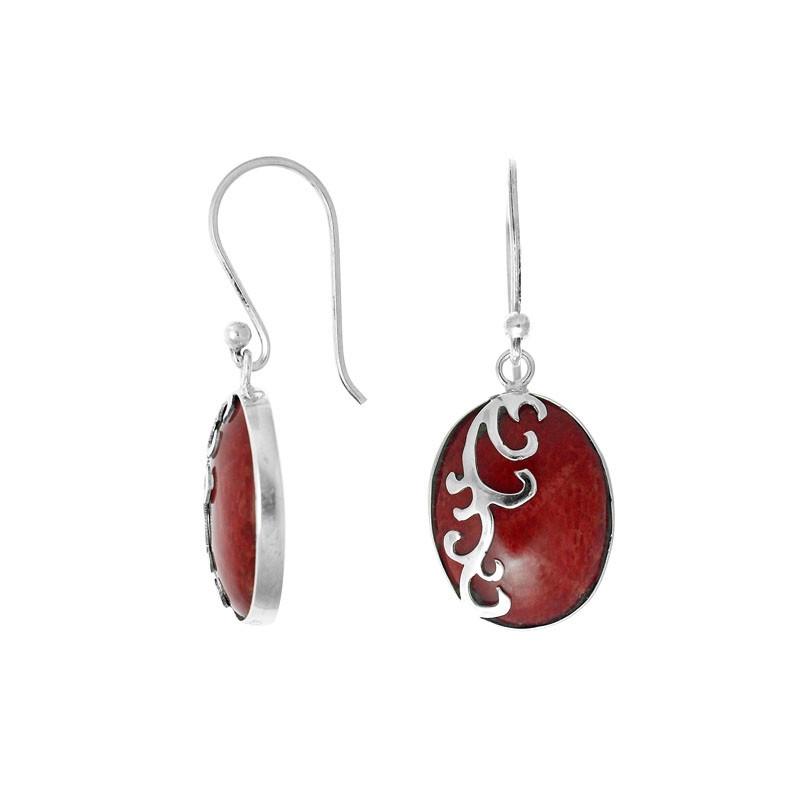 Wholesale sterling silver earrings featuring oval red coral drops with a polished wave-motif overlay, offering reliable craftsmanship and elegant presentation suitable for bulk jewelry orders.