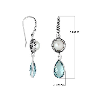 Wholesale sterling silver earrings featuring a round Mabe Pearl paired with a faceted Blue Topaz Quartz drop, surrounded by ornate Balinese detailing for consistent, catalog-quality wholesale presentation.