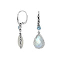 Wholesale sterling silver earrings featuring a faceted Rainbow Moonstone teardrop and Blue Topaz Quartz accent with ornate scroll designs and secure earwire, ideal for premium catalog displays.