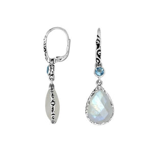 Wholesale sterling silver earrings featuring a faceted Rainbow Moonstone teardrop and Blue Topaz Quartz accent with ornate scroll designs and secure earwire, ideal for premium catalog displays.