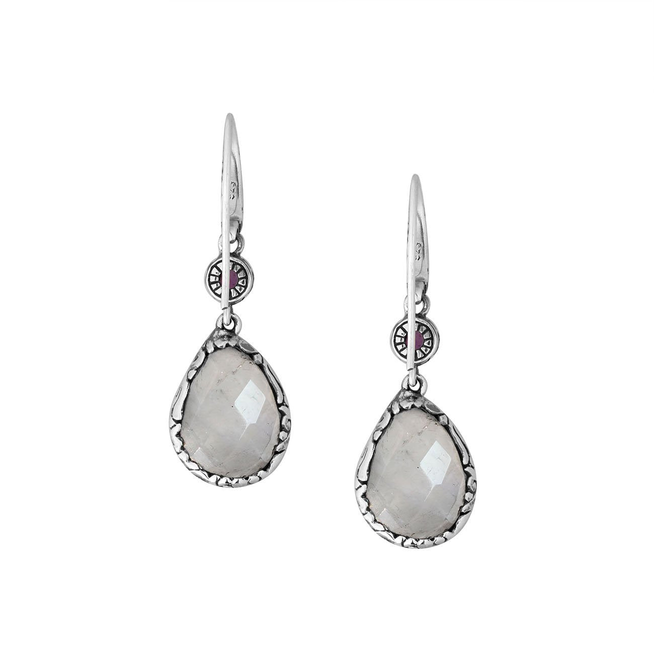 Wholesale sterling silver earrings combining a faceted rainbow moonstone teardrop with an amethyst quartz accent, framed by ornate Balinese detailing for consistent artisan quality and strong catalog-ready wholesale presentation.