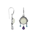 Wholesale sterling silver earrings featuring a carved bone face framed by ornate Balinese detailing, accented with blue topaz quartz and an amethyst quartz drop for consistent artisan-quality presentation.
