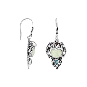 Wholesale sterling silver earrings featuring a carved Bone Face centerpiece adorned with Blue Topaz Quartz and Garnet Quartz accents, designed with ornate Balinese detailing for consistent artisan presentation.