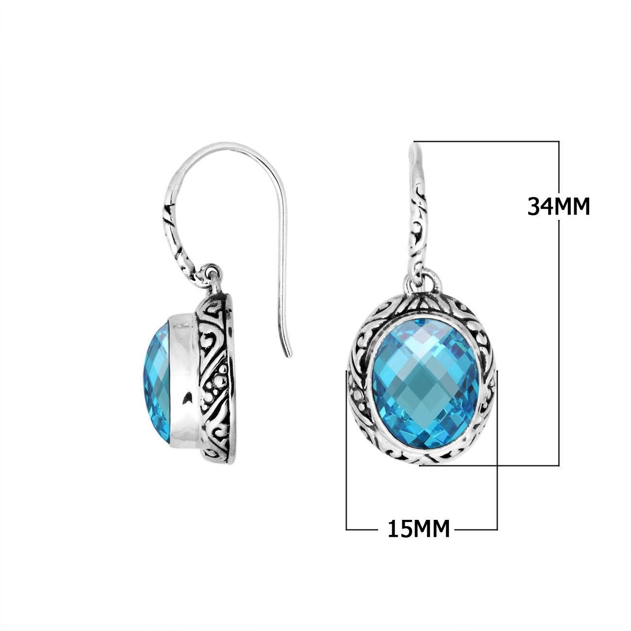Wholesale sterling silver earrings featuring a faceted oval Blue Topaz Quartz stone framed with carved silver detailing and earwire lock, offering vibrant color and artisan styling ideal for premium jewelry catalogs.