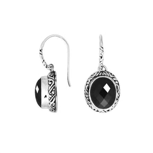 Wholesale sterling silver earrings featuring a faceted oval Black Onyx stone framed with carved silver detailing and earwire lock, offering bold contrast and artisan craftsmanship suited for premium wholesale jewelry catalogs.