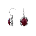 Wholesale sterling silver earrings featuring an oval faceted Ruby Quartz stone set within ornate carved silver detailing and an earwire lock, offering vibrant color and artisan style ideal for premium wholesale catalogs.