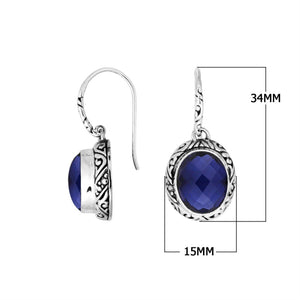 Wholesale sterling silver earrings featuring a faceted oval Sapphire stone framed with intricate carved detailing and earwire lock, offering deep blue brilliance and artisan craftsmanship ideal for premium wholesale jewelry catalogs.