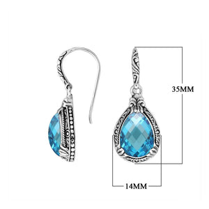 Wholesale sterling silver earrings featuring a faceted Blue Topaz Quartz teardrop framed with ornate carved detailing and an earwire lock, offering vivid color and artisan craftsmanship suited for premium wholesale jewelry catalogs.