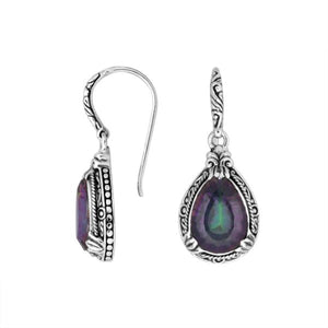Wholesale sterling silver earrings featuring a multicolor Mystic Quartz teardrop with shifting purple and green hues, framed in detailed carved borders and finished with an earwire lock for vibrant artisan wholesale collections.