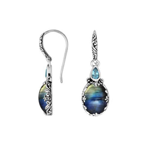 Wholesale sterling silver earrings featuring iridescent Labradorite topped with a bright Blue Topaz Quartz accent, framed with ornate carved detailing and earwire lock for a premium mystical dual-tone wholesale design.