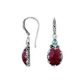Wholesale sterling silver earrings featuring a deep Ruby Quartz drop complemented by a bright Blue Topaz Quartz accent with ornate carved borders for premium catalog presentation.