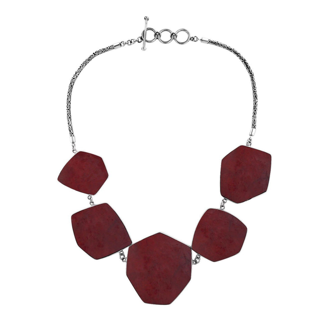Sterling silver necklace with hexagon-shaped red coral links, polished artisan finish.