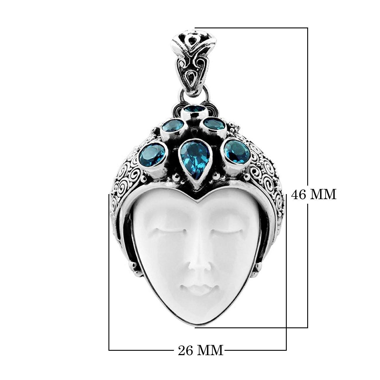 Wholesale sterling silver pendant with hand-carved bone goddess face and faceted blue topaz gemstones, handcrafted Balinese artisan jewelry design.