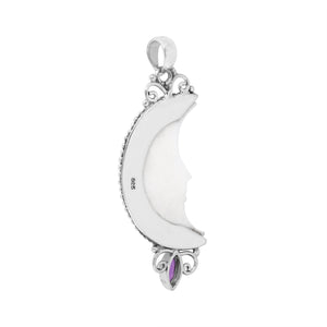 Sterling silver half-moon pendant with carved bone face and amethyst gemstone, Balinese design.